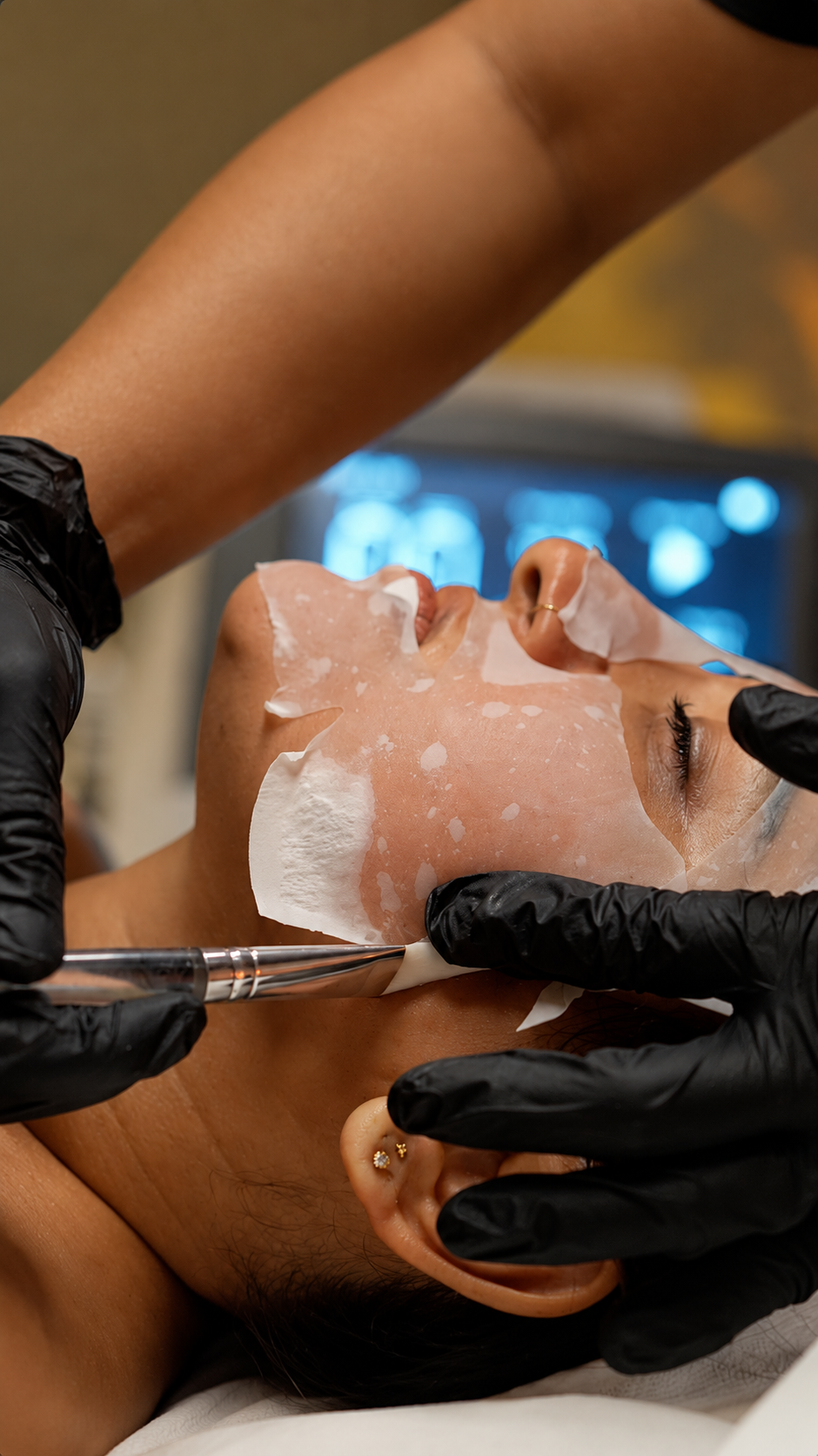 Illustrative image: Hands dispensing skincare onto a cotton pad