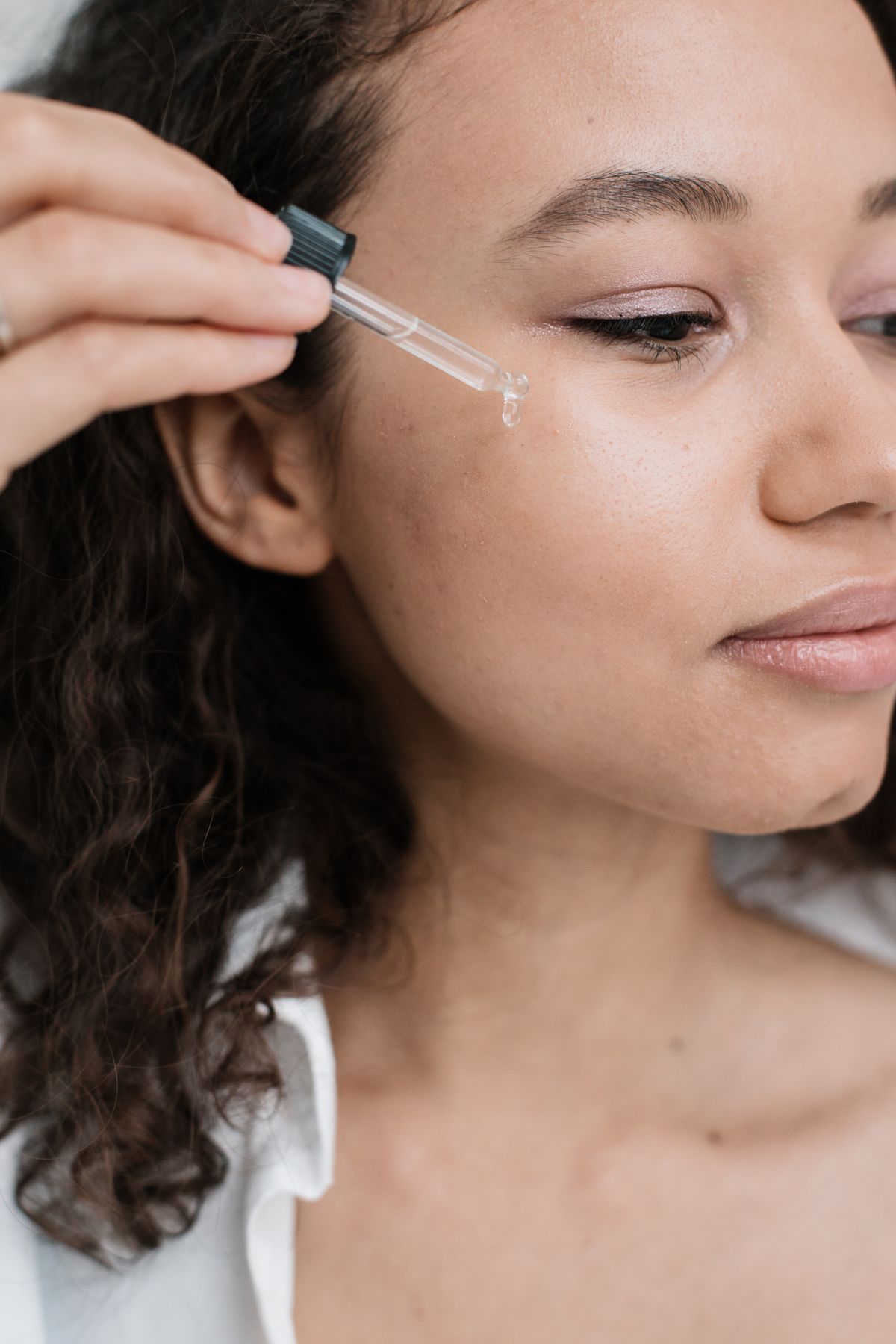 Illustrative image: A woman applying serum to her skin