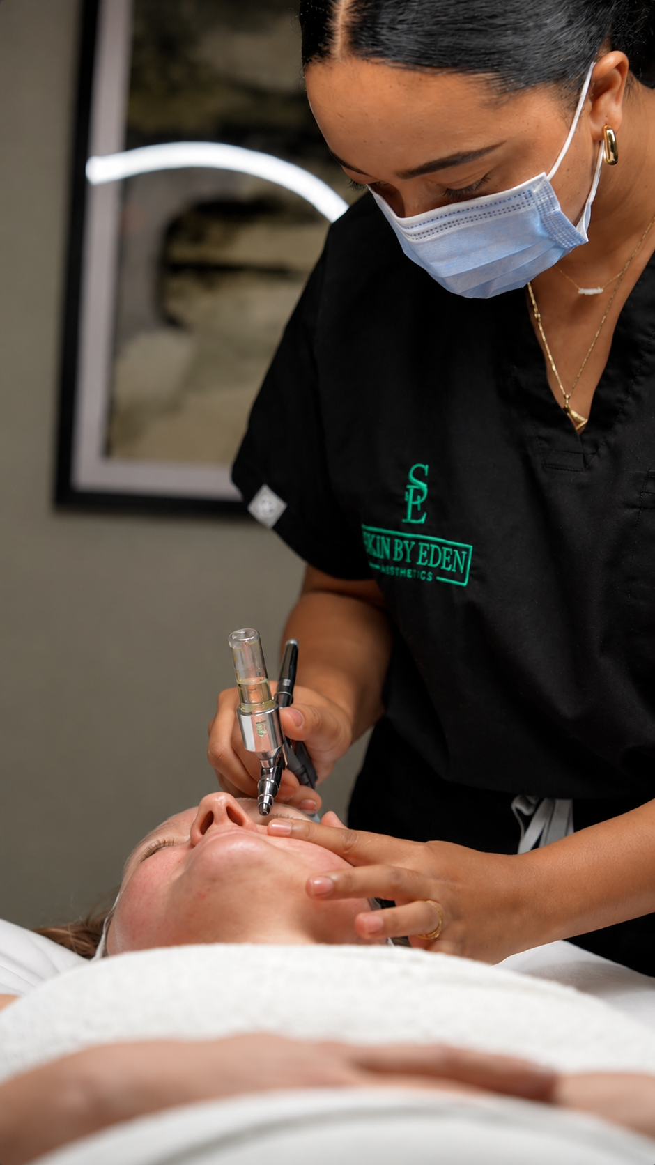 Illustrative image: Hands dispensing skincare onto a cotton pad