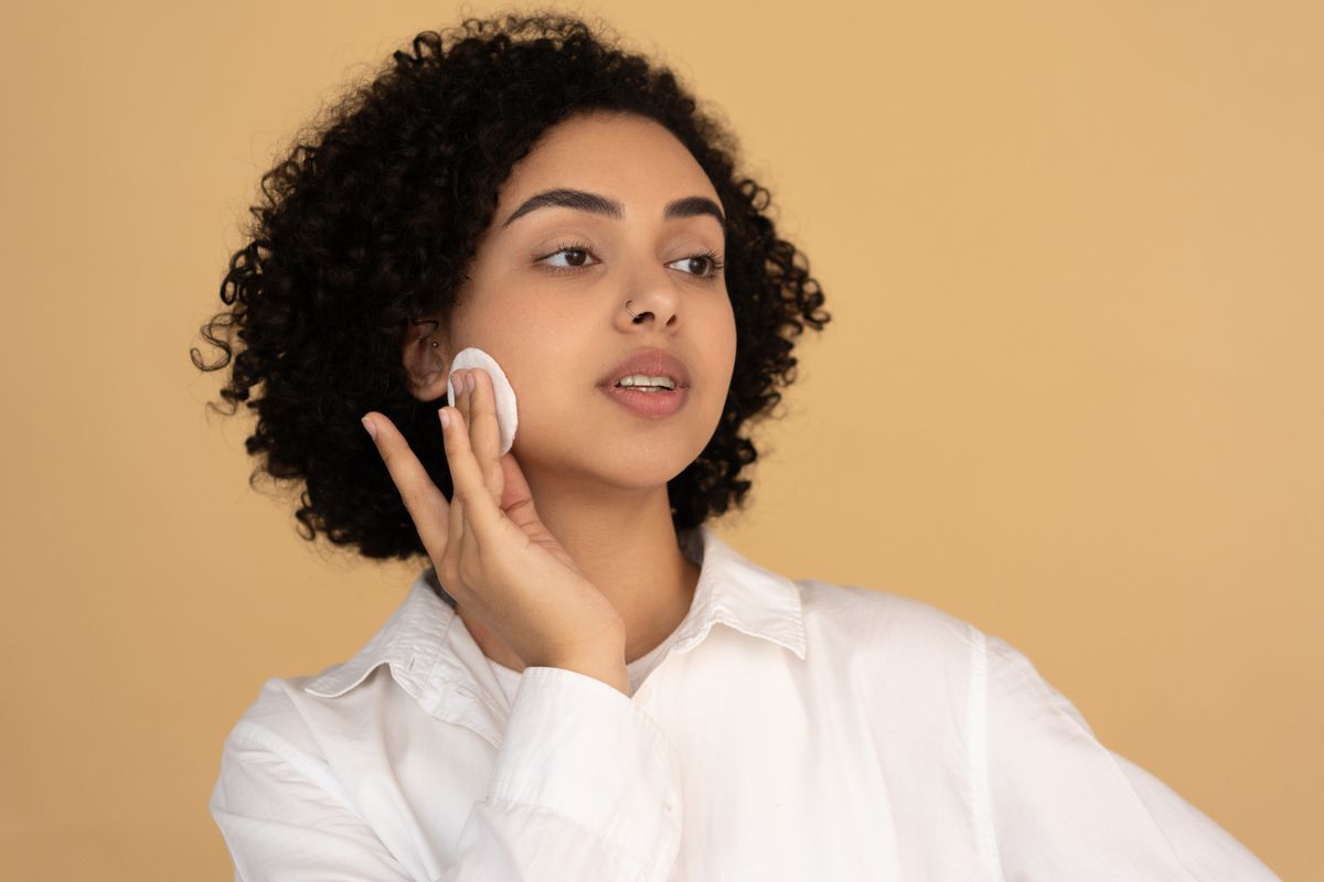 Illustrative image: A woman using a cotton pad during her skincare routine