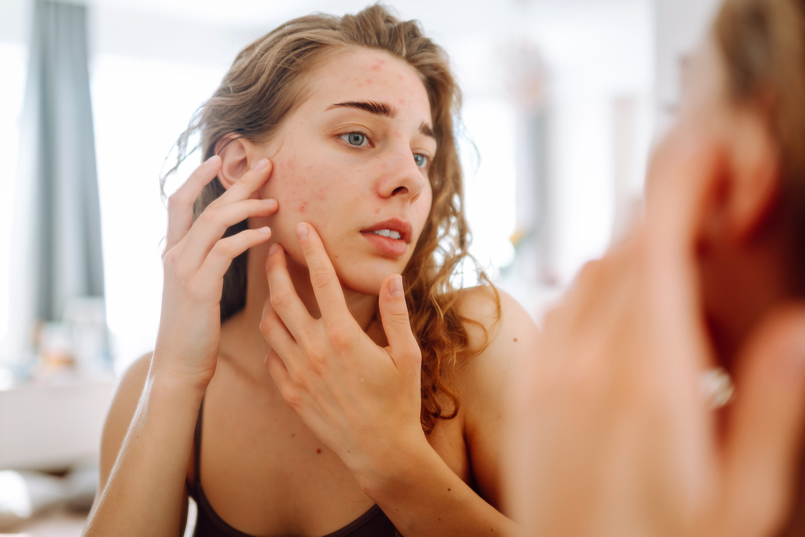 Illustrative image: A woman applying skincare with a dropper
